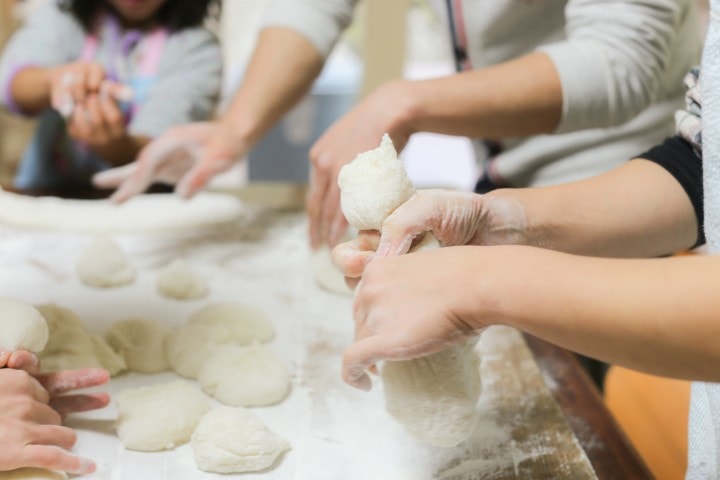 A group of bakers preparing mochi by hand