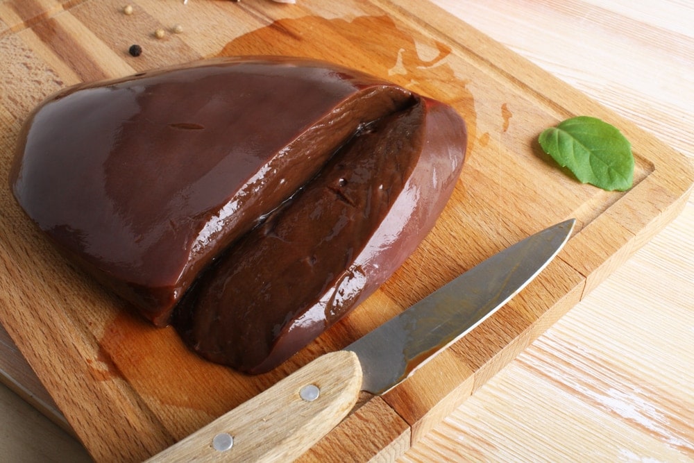 Beef liver on a wooden background