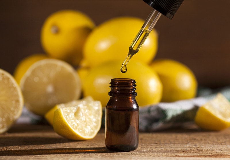 Lemon essential oil and lemon fruits