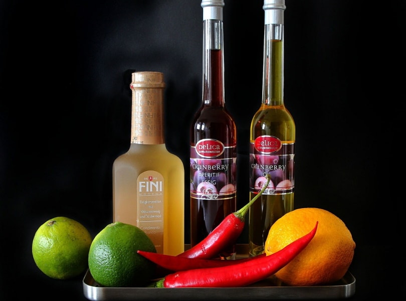 Variety of vinegar with citrus fruits and chili
