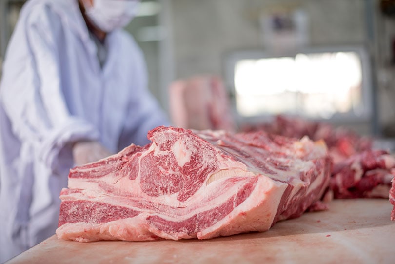 butcher cutting meat