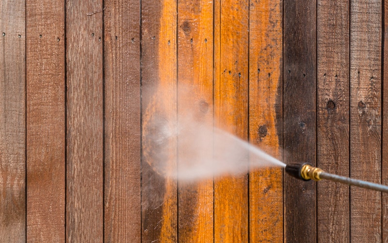 high pressure washer cleaning wooden fence