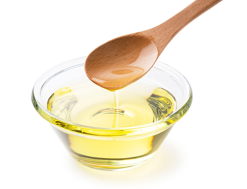 scooping a bowl of vegetable oil