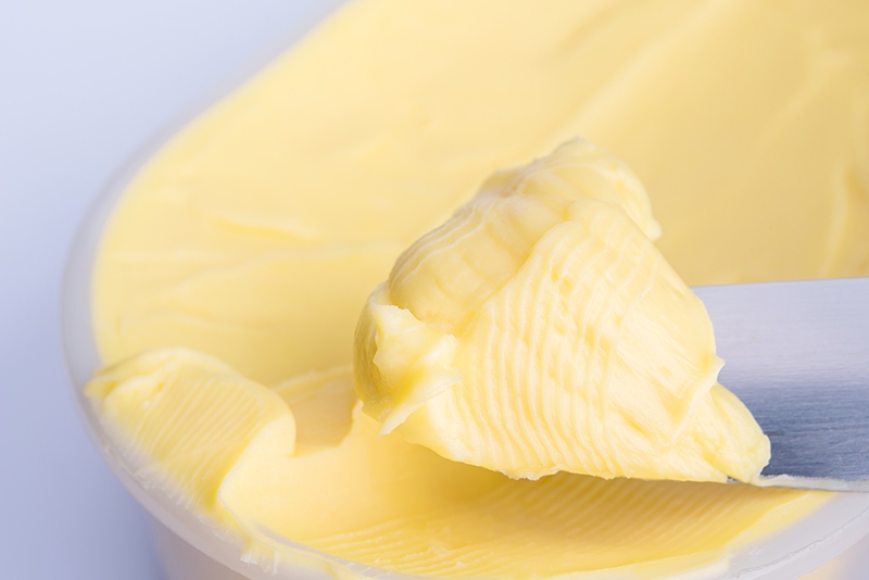 scooping margarine using knife