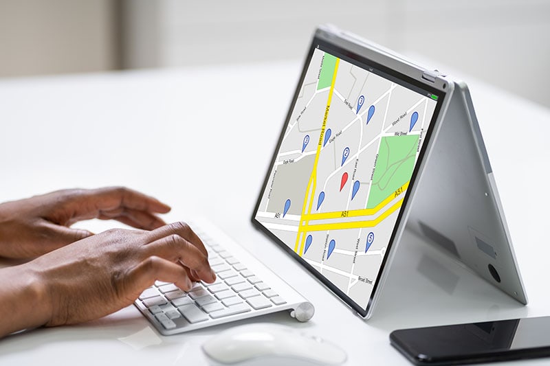 searching map online at a laptop