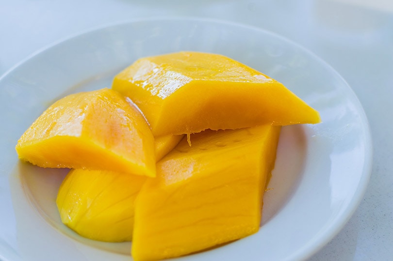 sliced mango on a white saucer
