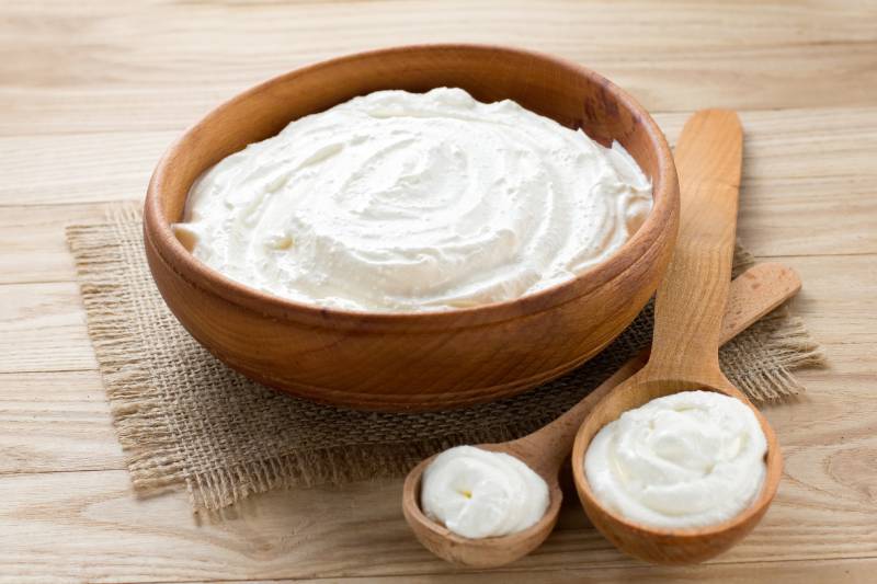 sour cream in a wooden bowl