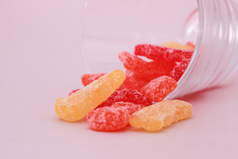 sour patch kids candy spilling out of cup