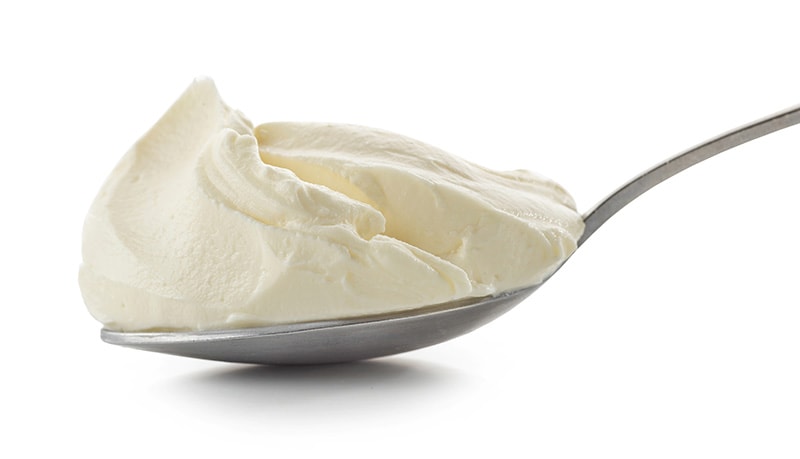 spoon of cream cheese isolated on white background