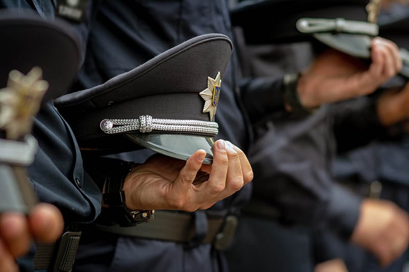 uniform cap in the hand of policemen