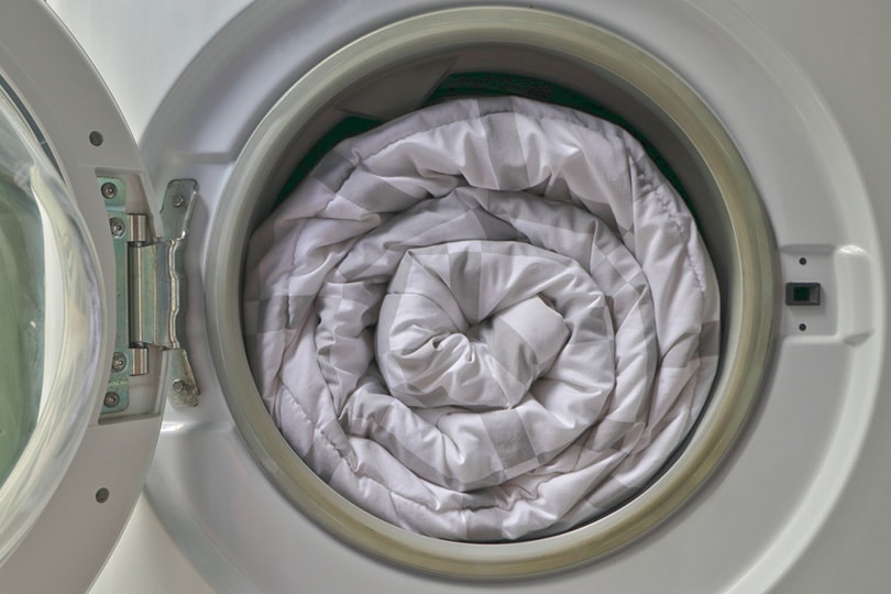white comforter inside the washing machine