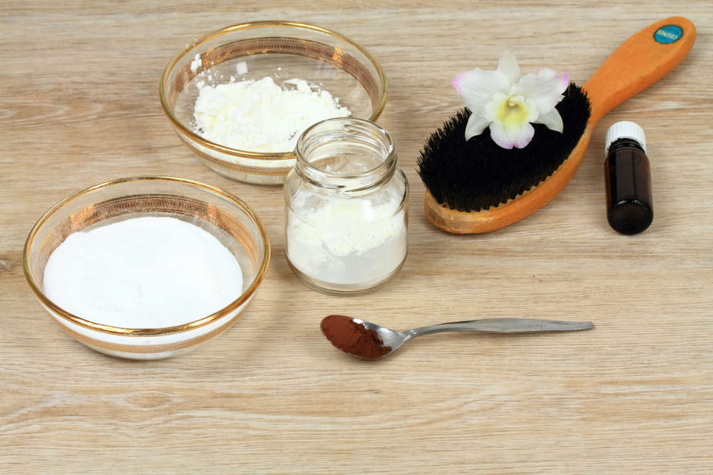 Homemade dry shampoo in a jar made of powder corn starch, baking soda and essential oil