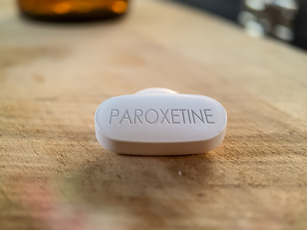 Paroxetine pill on wooden table close up